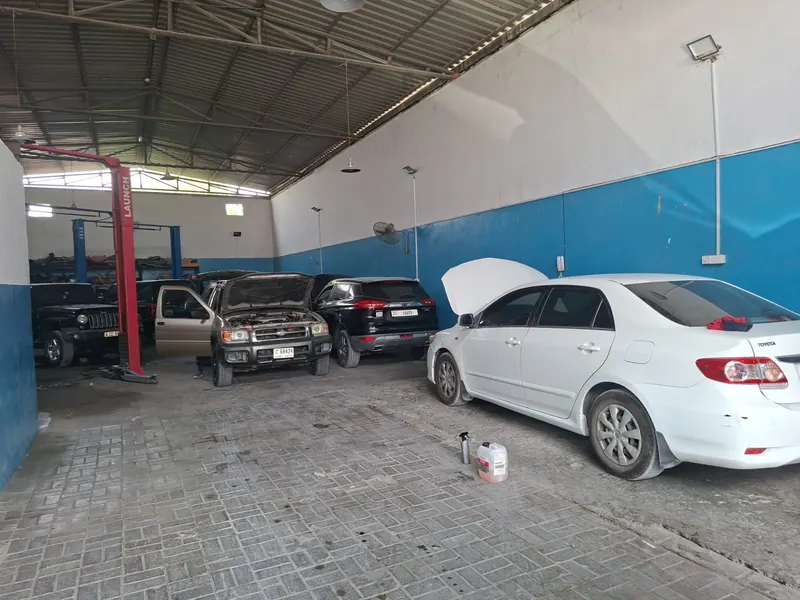 Covered workshop bay with cars under repair